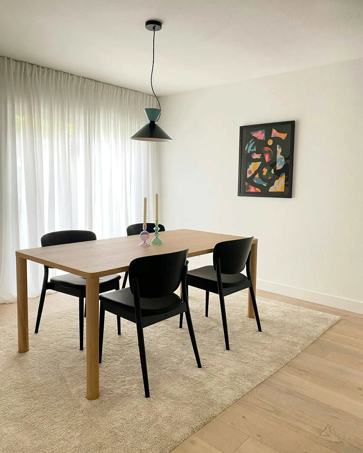 A rectangular dining table with matching black chairs