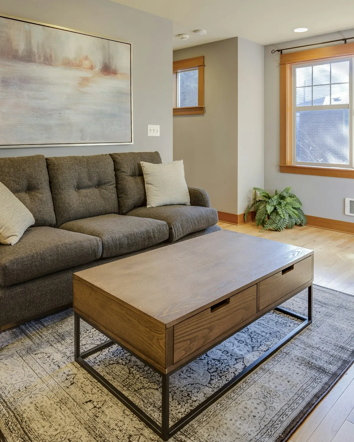A living room with a straight sofa and a rectangular coffee table