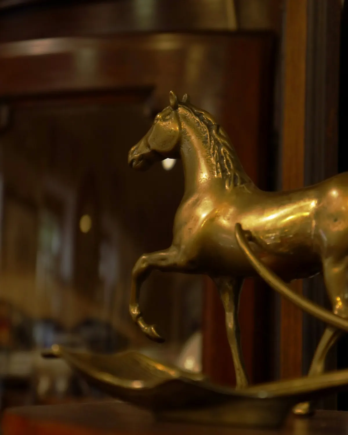 A small brass horse catching warm light