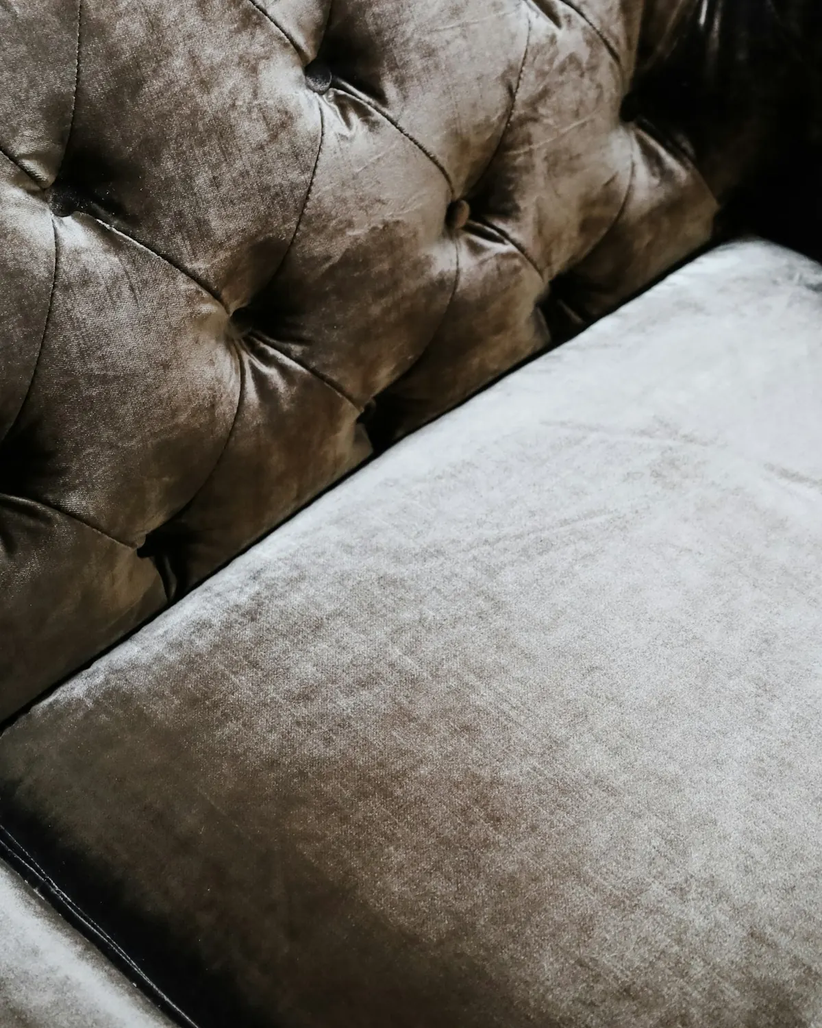 Close-up of a tufted velvet sofa