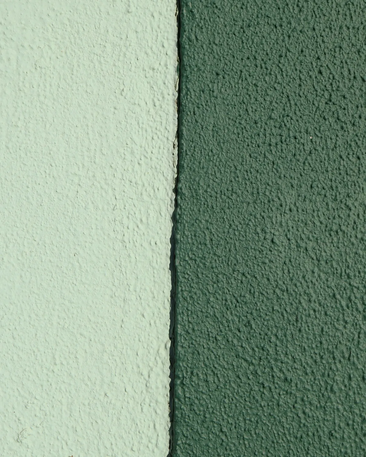Two shades of green side by side on a wall