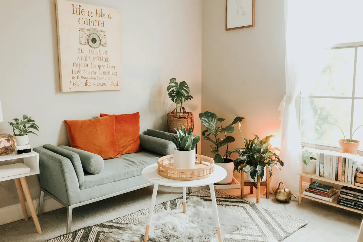 A small living room with a round coffee table and plants