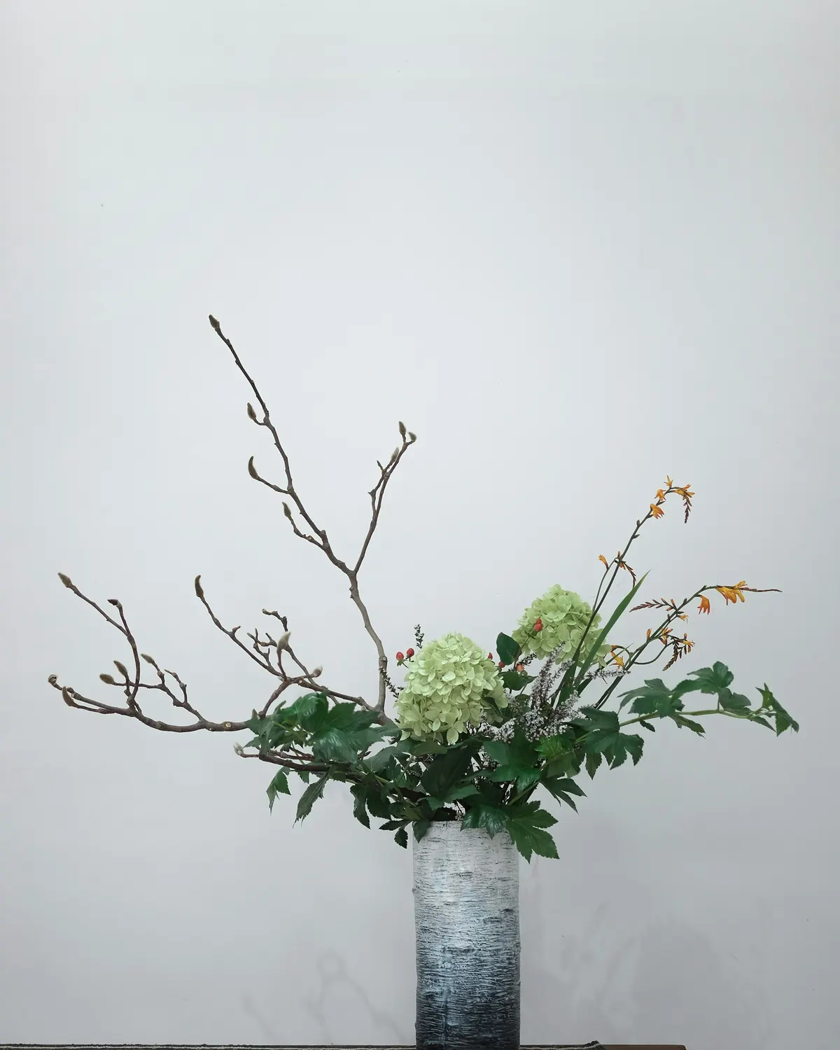 Branches and greenery in a simple vase