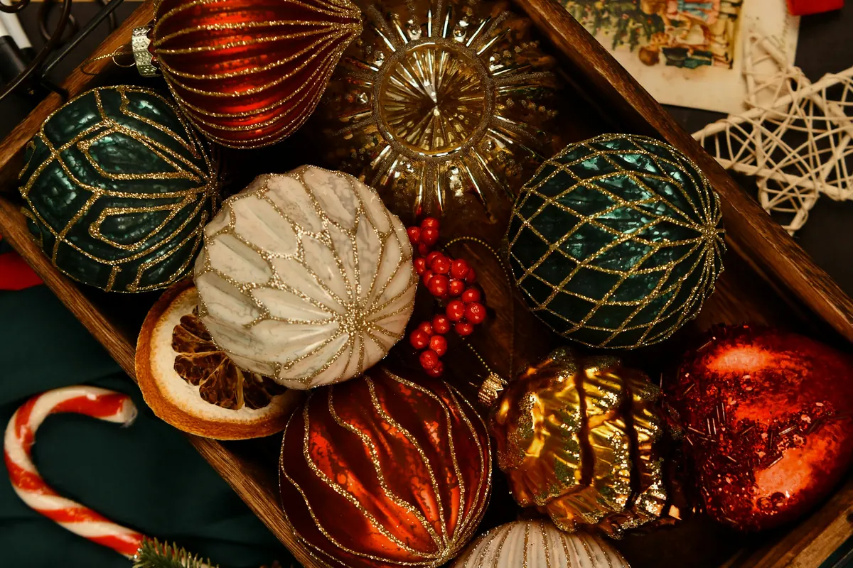 A wooden box of vintage Christmas ornaments
