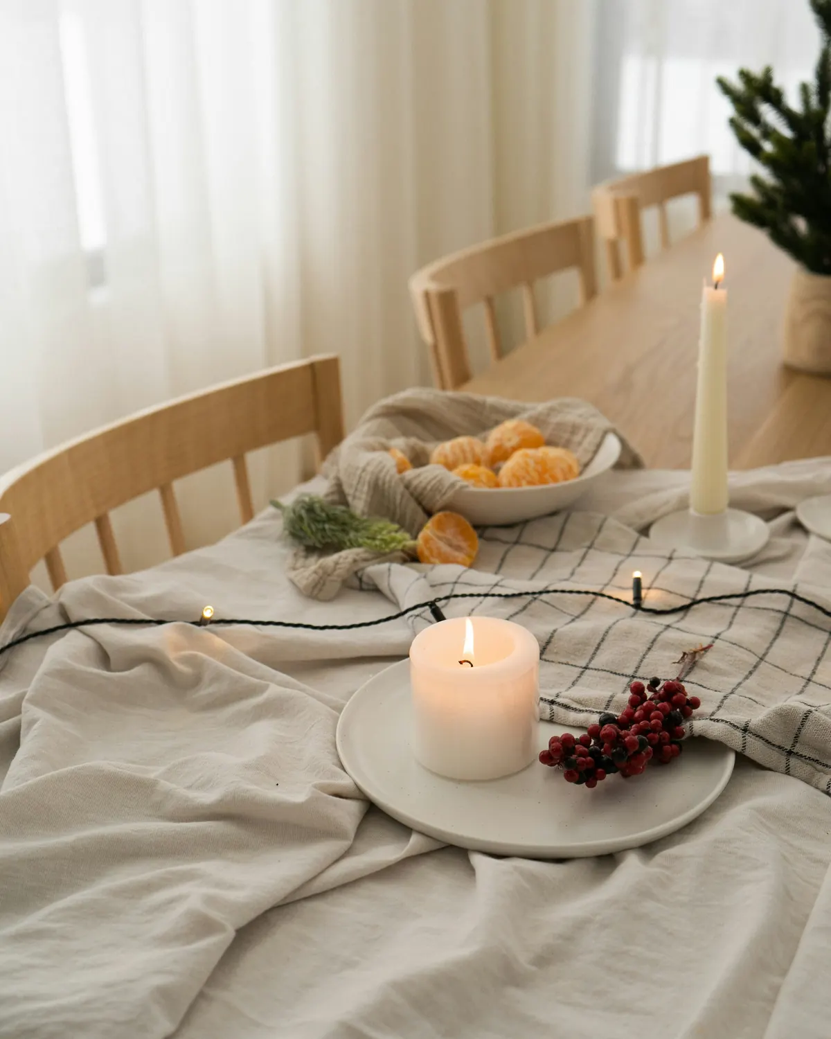 Holiday table with a soft linen cloth and a candle
